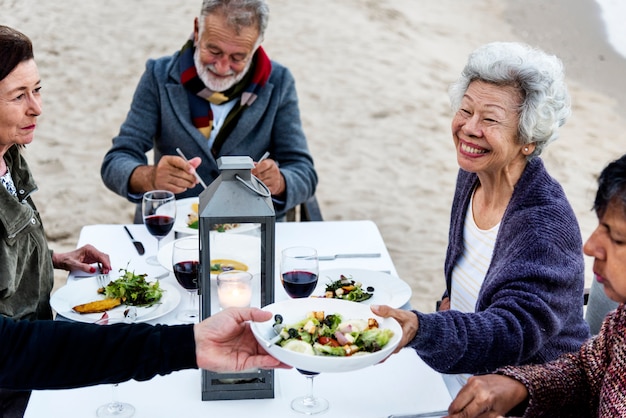 Seniors having a dinner party at the beach