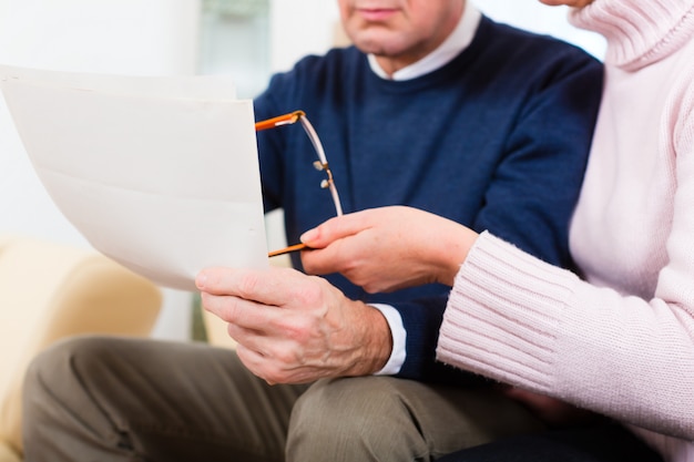 Seniors at home receiving letter being upset