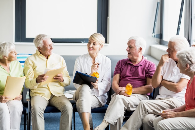 Seniors and nurse holding documents