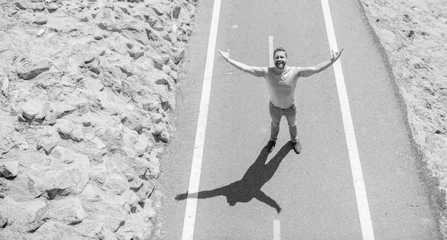 Sense of freedom healthy lifestyle mature man looking up on road full of happiness