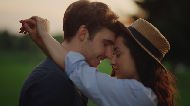 Sensual couple dancing in slow motion at park at sunset Romantic man and woman