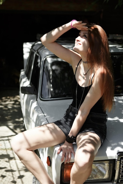 Sensual model posing on car