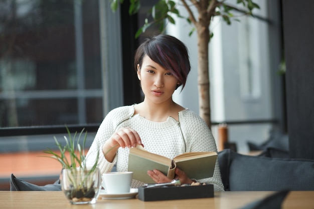 Sensual woman with book and coffee