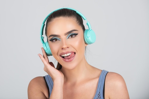 Sensual young woman listening music with headphones