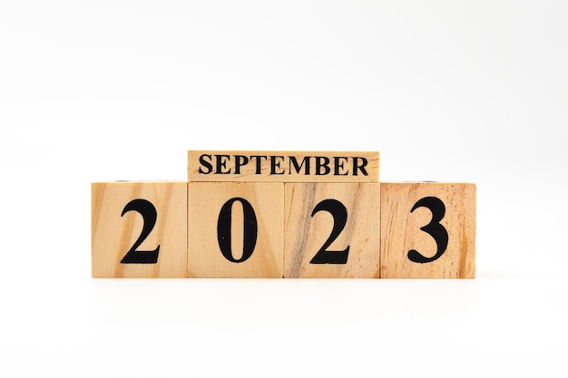 September 2023 written on wooden blocks isolated on white background with copy space