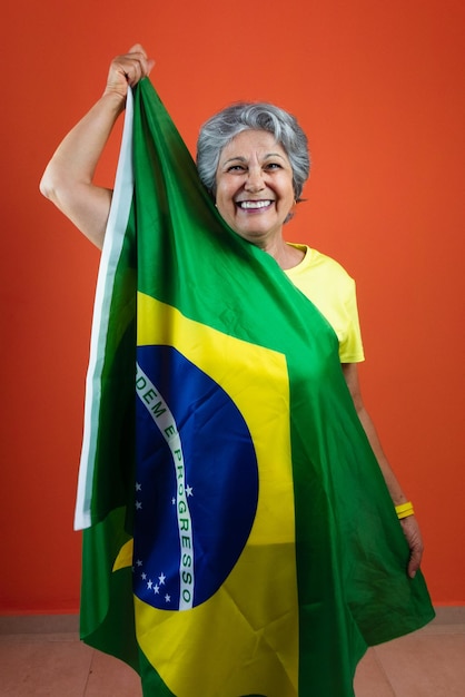 September 7th Brazil Independence Day Mature Woman with Gray Hair yellow shirt and flag isolated