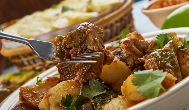 Serbian Goulash-Paprikash, Balkan cuisine cuisine, Traditional assorted dishes, Top view.ade with onions, olive oil, lamb, bay leaves, tomato paste, water, paprika, red chile.