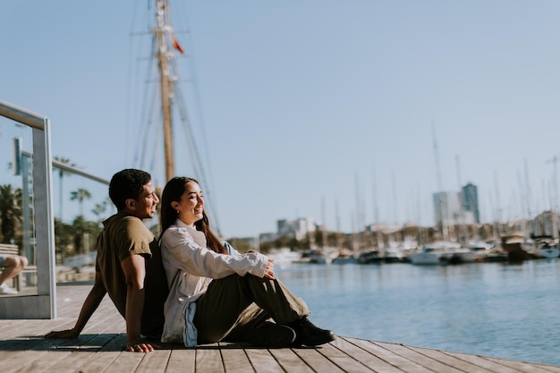 Serene afternoon at Barcelona marina couple relaxing by tranquil waters