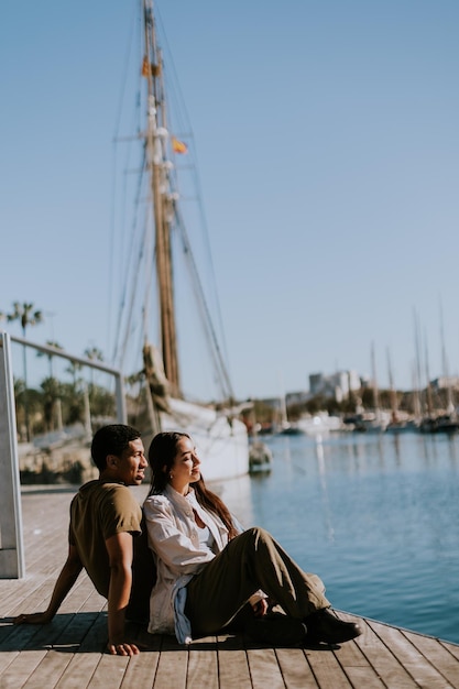 Serene afternoon at Barcelona marina couple relaxing by tranquil waters