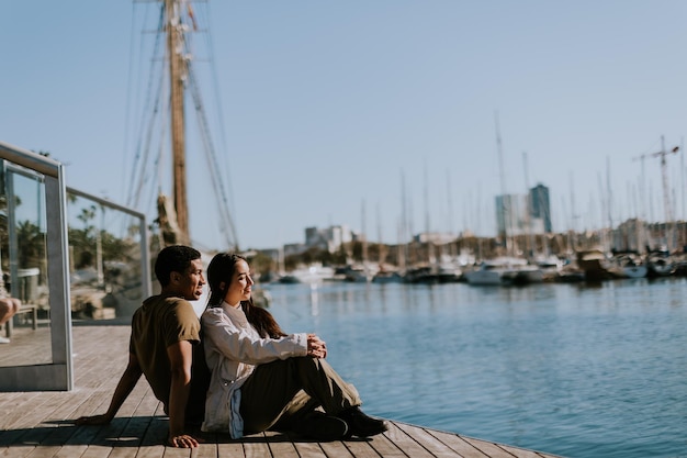 Serene afternoon at Barcelona marina couple relaxing by tranquil waters