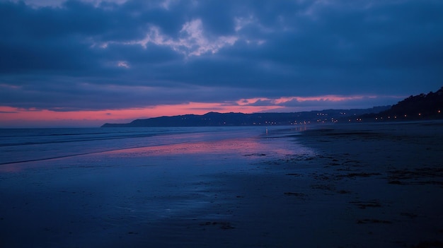 Photo serene beach at dusk with soft waves and a colorful sky reflecting on the water