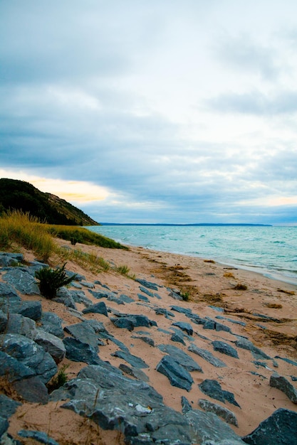 Serene Dawn on Lake Michigan Shore with Rocky Pathway