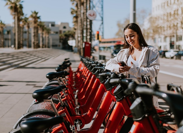 A serene spring afternoon in Barcelona with a smiling woman renting a bicycle