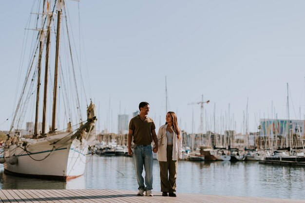 Serene stroll along Barcelona marina at with vintage sailing vessel