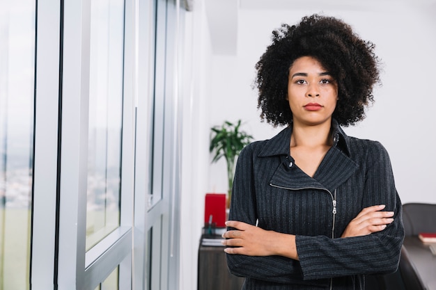 Serious African American young lady near window