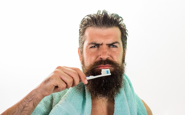 Serious bearded man brushing teeth tooth brush tooth paste morning treatments morning routine health