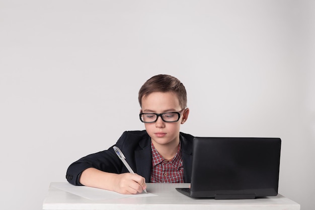 Serious business boy writing with pen