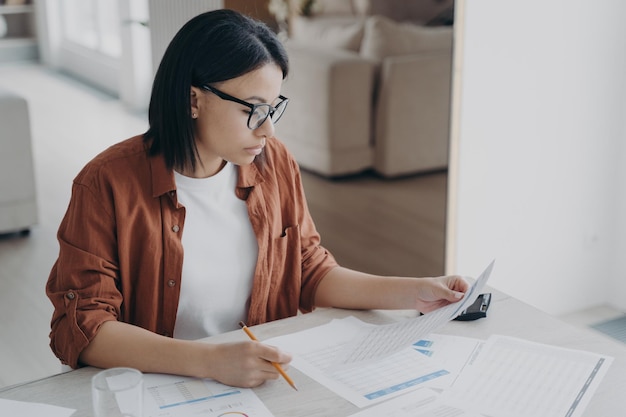 Serious business lady is examining documents Intelligent professional and business strategy