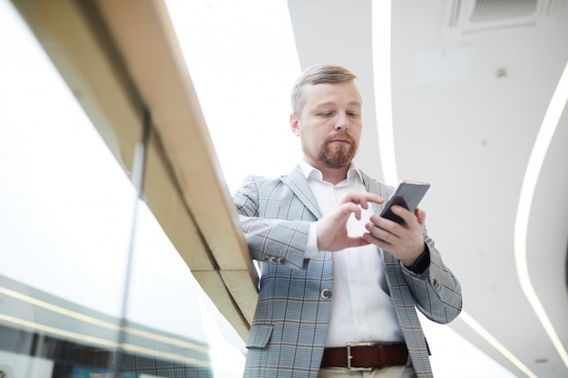 Serious businessman checking messenger