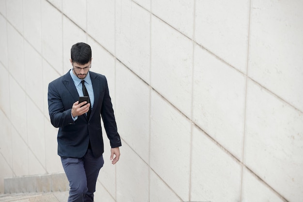 Serious Businessman Checking Smartphone