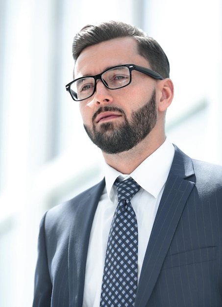 Serious businessman standing in a spacious office