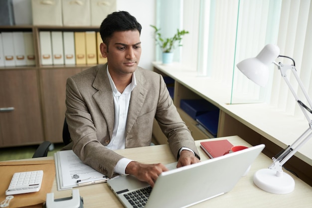 Serious Businessman Working on Laptop