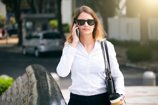 Serious Businesswoman Calling on Phone