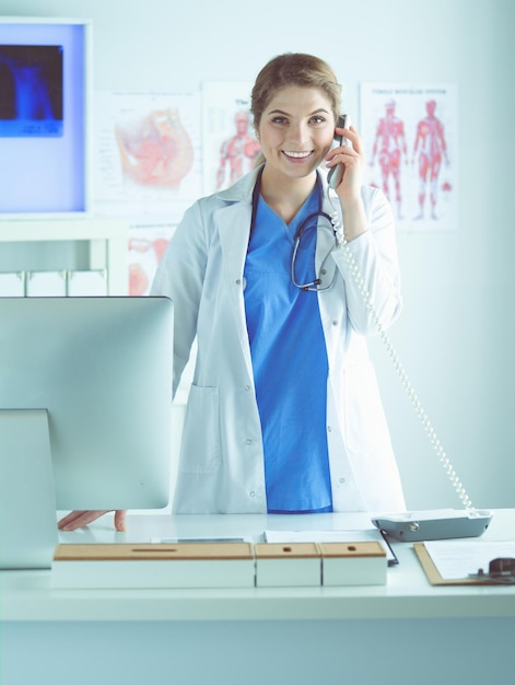 Serious doctor on the phone in her office