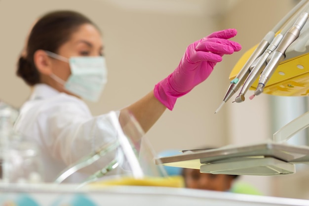 Serious female doctor preparing for treating her patient