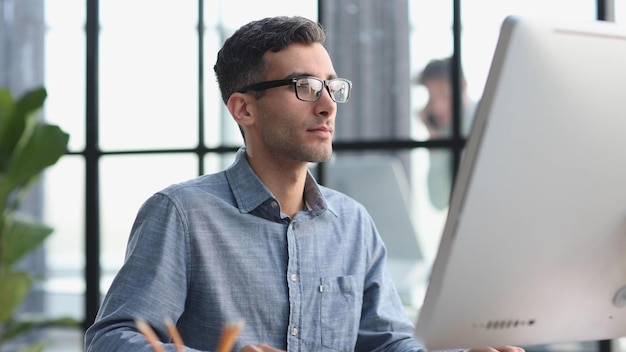 Serious and focused financier accountant on paper work inside office