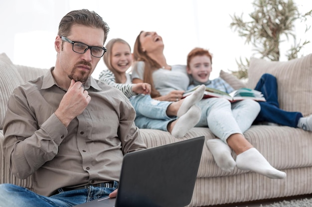 Serious male freelancer working in his living room people and technology