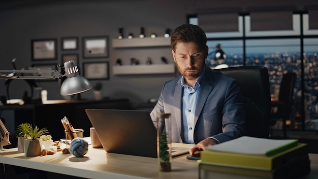 Serious man receiving cellphone message in evening workplace closeup guy work