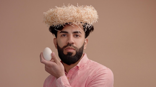 Serious man with a nest on the head put an egg in the nest Father's day Easter greeting video card