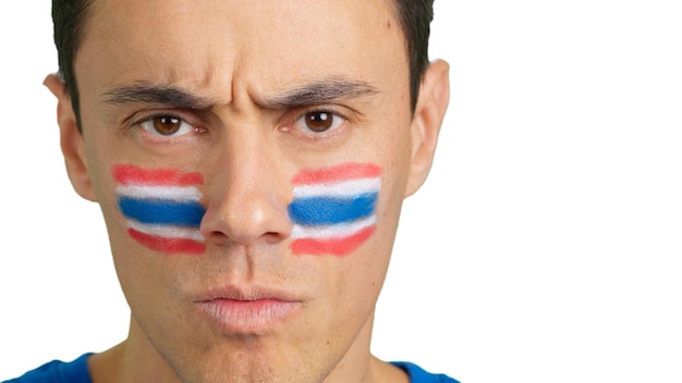 Serious man with a thai flag painted on the face