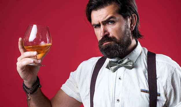 Serious mature man drinking whiskey from glass restaurant