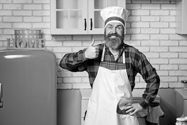 Serious satisfied bearded chef cook or baker gesturing excellent