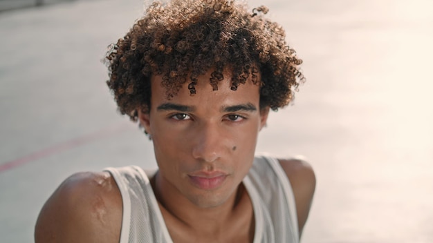 Serious teenager looking camera street portrait young sportsman face resting