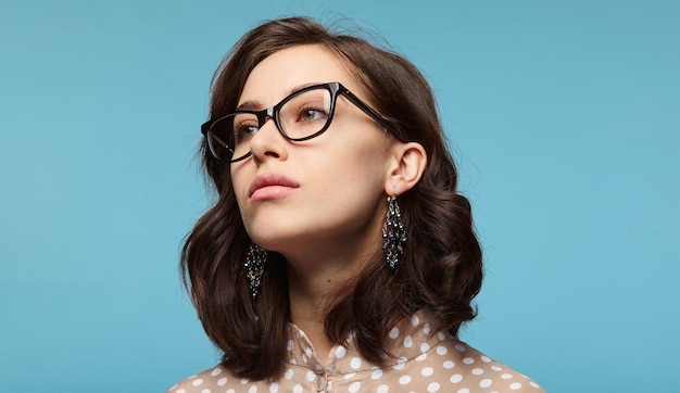 Serious trendy woman in glasses