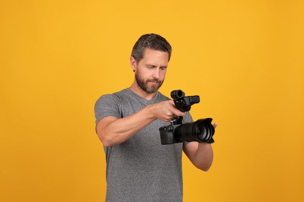 Serious videographer making video movie maker make vlog professional filmmaker hold videocamera cinematography backstage of filming cameraman vlogging with film set bearded man with camcorder