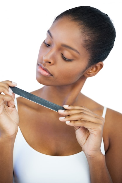 Serious woman looking at her nail file