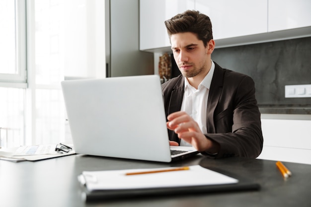 Serious young businessman working indoors.