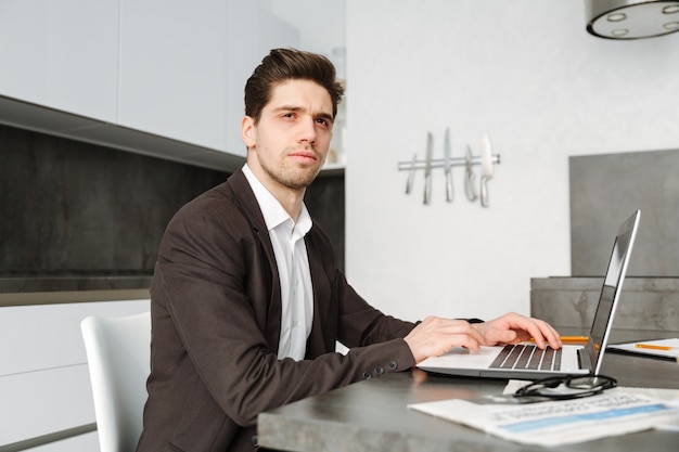 Serious young businessman working indoors