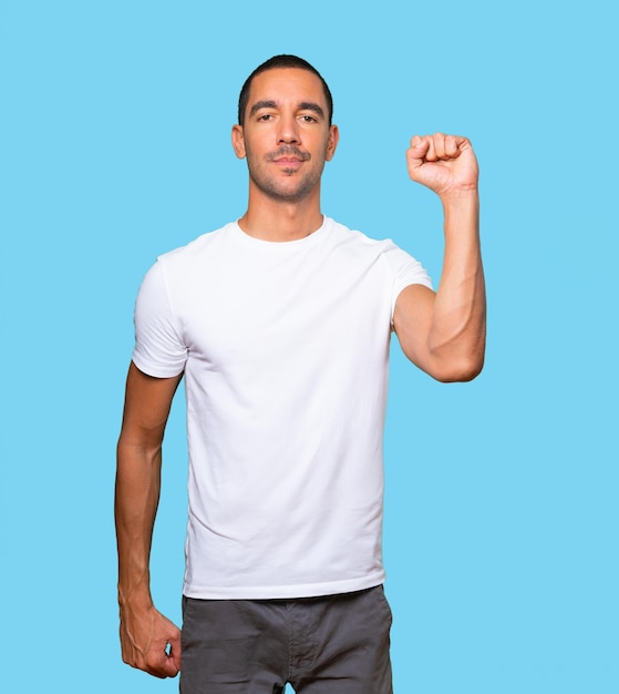 Serious young man with his fist up