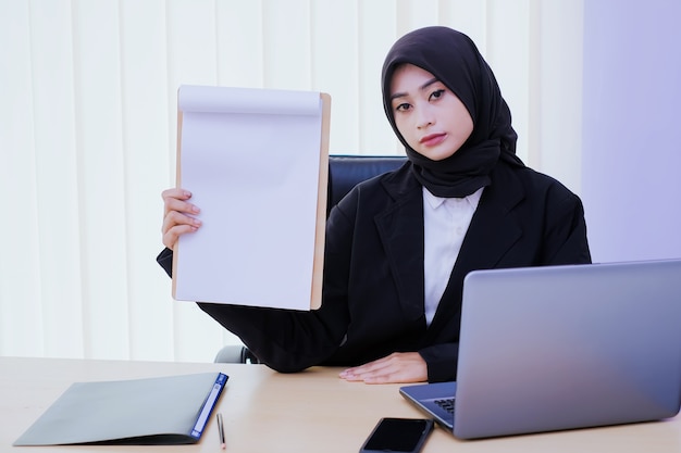 Seriously business young woman holding a financially document in the office