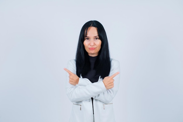 Seriously girl is looking at camera by crossing hands on white background