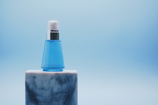 Serum bottle on blue background luxury skincare products beauty and cosmetics