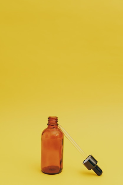 Serum bottle on yellow background