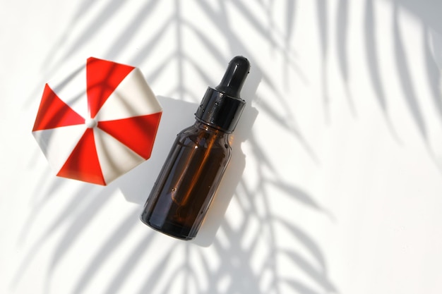 Serum in brown bottle on on a white background