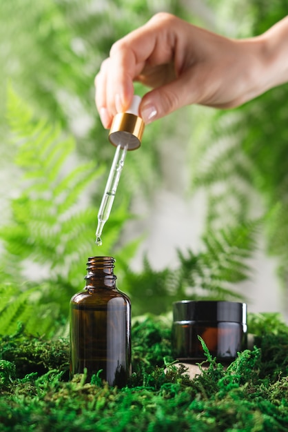 Serum and face care cream in glass bottles