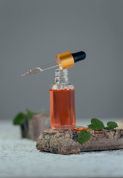 Serum in a glass bottle with a pipette. Essential oil for the care of women's skin.